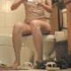 A woman sits down on a toilet, lights a cigarette, takes a normal shit with a couple of plops, pees, and then has some spurts of gassy and gurgling diarrhea after pushing for a while.